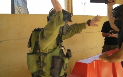 An IDF soldier sparring in full combat gear