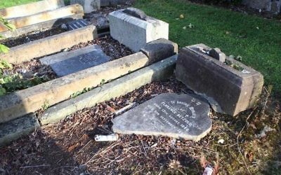 Headstones were smashed and knocked over Friday at a municipal cemetery in West Belfast, Northern Ireland.