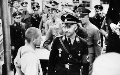 Himmler (front right) beside a prisoner whilst visiting the Dachau Concentration Camp in 1936