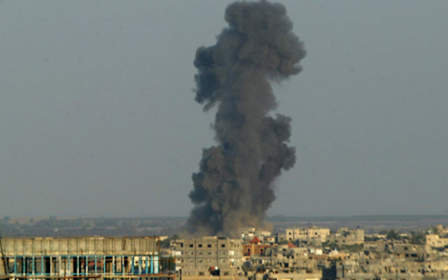 Smoke is seen after an Israeli air strike in Rafah in the southern Gaza strip, August 19, 2014.