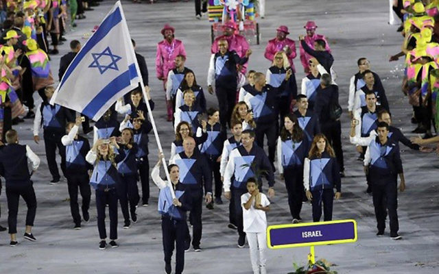 Neta Rivkin leads the Israeli delegation out at the opening ceremony, prior to which, Lebanese officials refused to allow Israeli athletes to board a bus with them to take them to the stadium