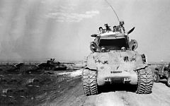 A Israeli tanks passes the remains of a Syrian tank in the Golan Heights in Israel during the Yom Kippur War on Oct. 9, 1973. (AP Photo/Spartaco Bodini) A Israeli tanks passes the remains of a Syrian tank in the Golan Heights in Israel during the Yom Kippur War on Oct. 9, 1973. (AP Photo/Spartaco Bodini)