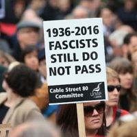 Demonstrators march for Cable Street in the East End of London. (Photo credit: Jonathan Brady/PA Wire)