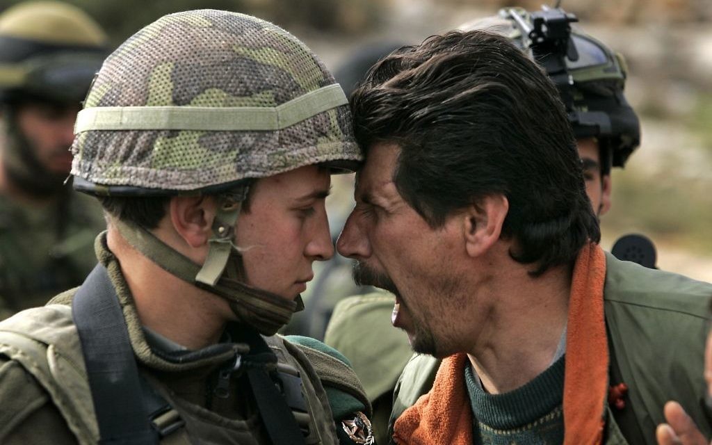 A Palestinian man argues with an Israeli soldier during a demonstration near the West Bank city of Ramallah.