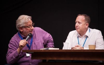 Momentum chief Jon Lansman (left), in a heated discussion next to the chair of the Jewish Labour Movement Jeremy Newmark  (Photo Credit: Eli Gaventa)