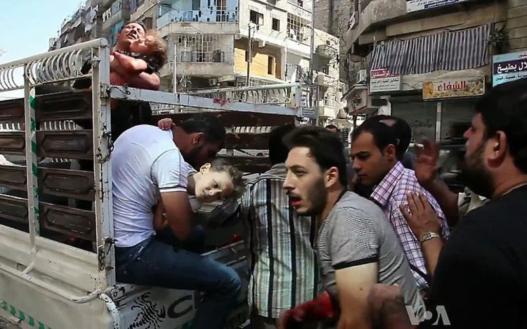 Wounded civilians arrive at a hospital in Aleppo during the Syrian civil war.