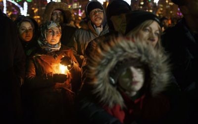 People gather in remembrance of the victims of Sunday's shooting at a Quebec City mosque, during a vigil in Edmonton, Alberta, Monday, Jan. 30, 2017. A French Canadian known for far-right, nationalist views was charged Monday with six counts of first-degree murder and five counts of attempted murder over the shooting rampage at a Quebec City mosque that Canada's prime minister called an act of terrorism against Muslims. (Jason Franson/The Canadian Press via AP)