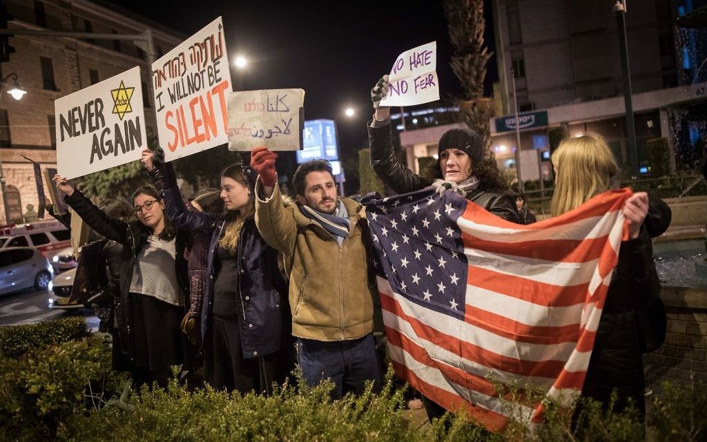 Protesters holding placards during near the Prime minister residence in Jerusalem against Trump’s recent anti-refugee and anti-migrant Executive Orders (Photo by: JINIPIX)