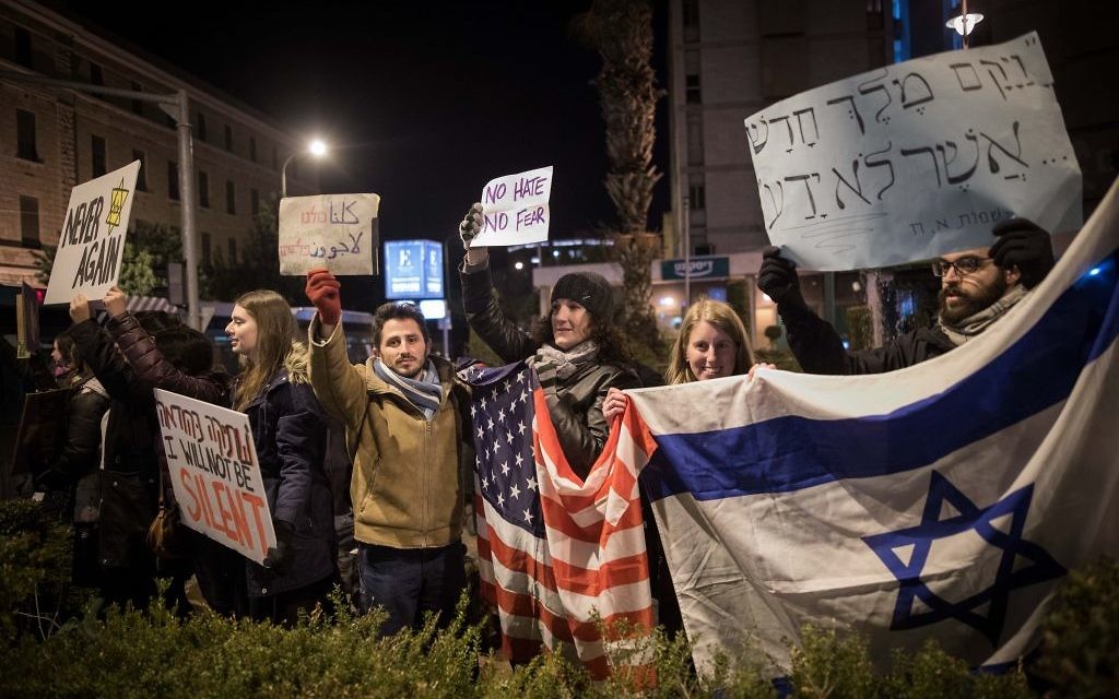 Protesters holding placards during near the Prime minister residence in Jerusalem against Trump’s recent anti-refugee and anti-migrant Executive Orders (Photo by: JINIPIX)