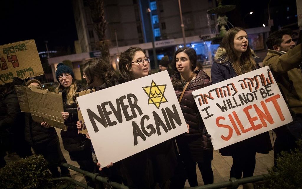 Protesters holding placards during near the Prime minister residence in Jerusalem against Trump’s recent anti-refugee and anti-migrant Executive Orders (Photo by: JINIPIX)