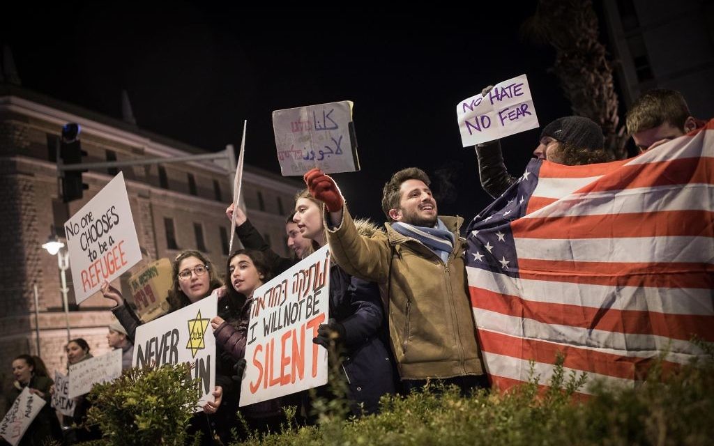 Protesters holding placards during near the Prime minister residence in Jerusalem against Trump’s recent anti-refugee and anti-migrant Executive Orders (Photo by: JINIPIX)