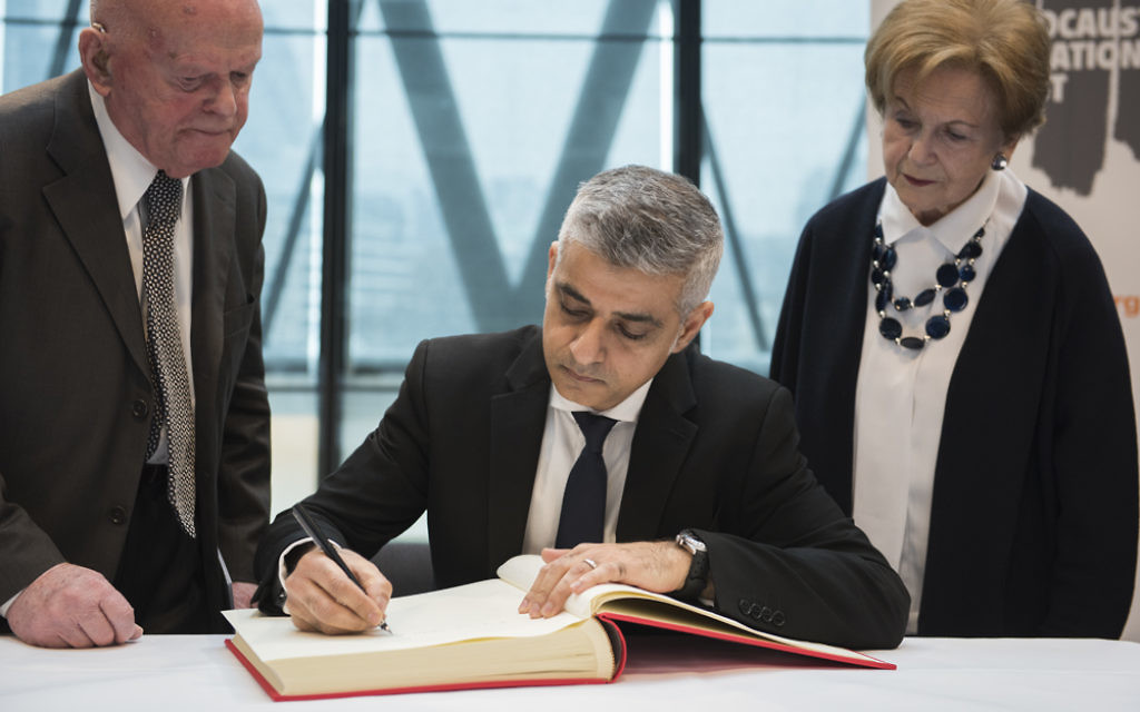 Sadiq Khan signing the Holocaust Educational Trust's  book of commitment, alongside Holocaust survivors Ben Helfgott (left) and Mala Tribich (right)