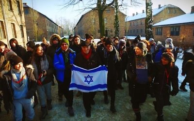 Leslie leads 100 students from Manchester King David and Yavneh schools out of Auschwitz