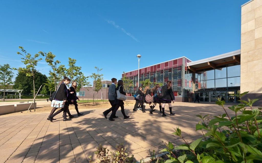 Stock photo of children outside a school.
