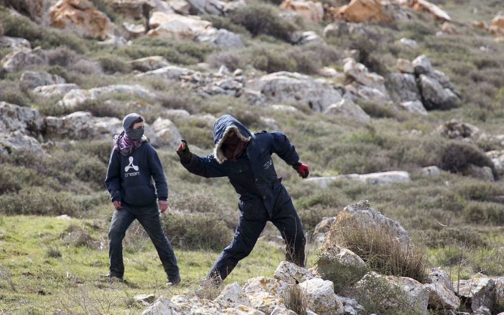 Settlers throw stones at police in Amona outpost in the West Bank (AP Photo/Ariel Schalit)