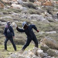 Settlers throw stones at police in Amona outpost in the West Bank (AP Photo/Ariel Schalit)