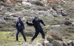 Settlers throw stones at police in Amona outpost in the West Bank (AP Photo/Ariel Schalit) Settlers throw stones at police in Amona outpost in the West Bank (AP Photo/Ariel Schalit)