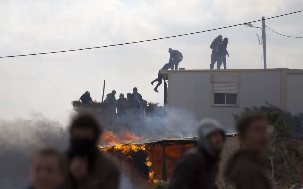 Settlers climb on top of a trailer in Amona outpost in the West Bank  (AP Photo/Ariel Schalit)