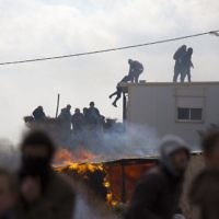 Settlers climb on top of a trailer in Amona outpost in the West Bank  (AP Photo/Ariel Schalit)
