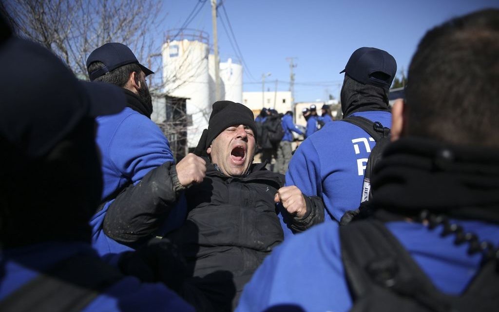 Israeli police detain settlers in the West Bank outpost of Amona.