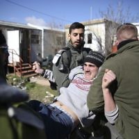 Israeli police detain settlers in the West Bank outpost of Amona,  earlier in February  (AP Photo/Oded Balilty)
