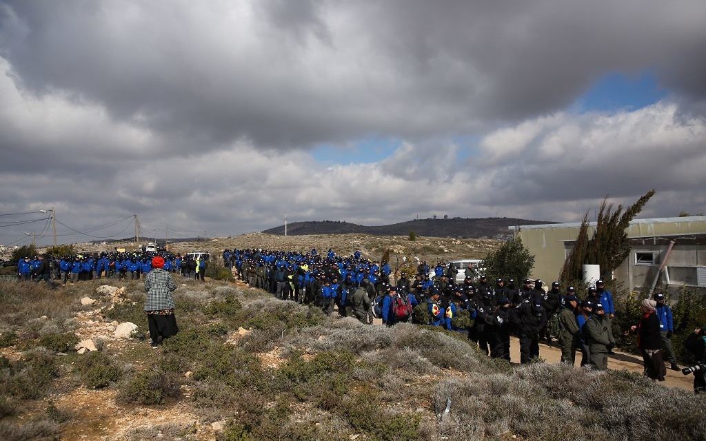 Israeli police evict settlers from the West Bank outpost of Amona, Wednesday. (Photo by: JINIPIX)