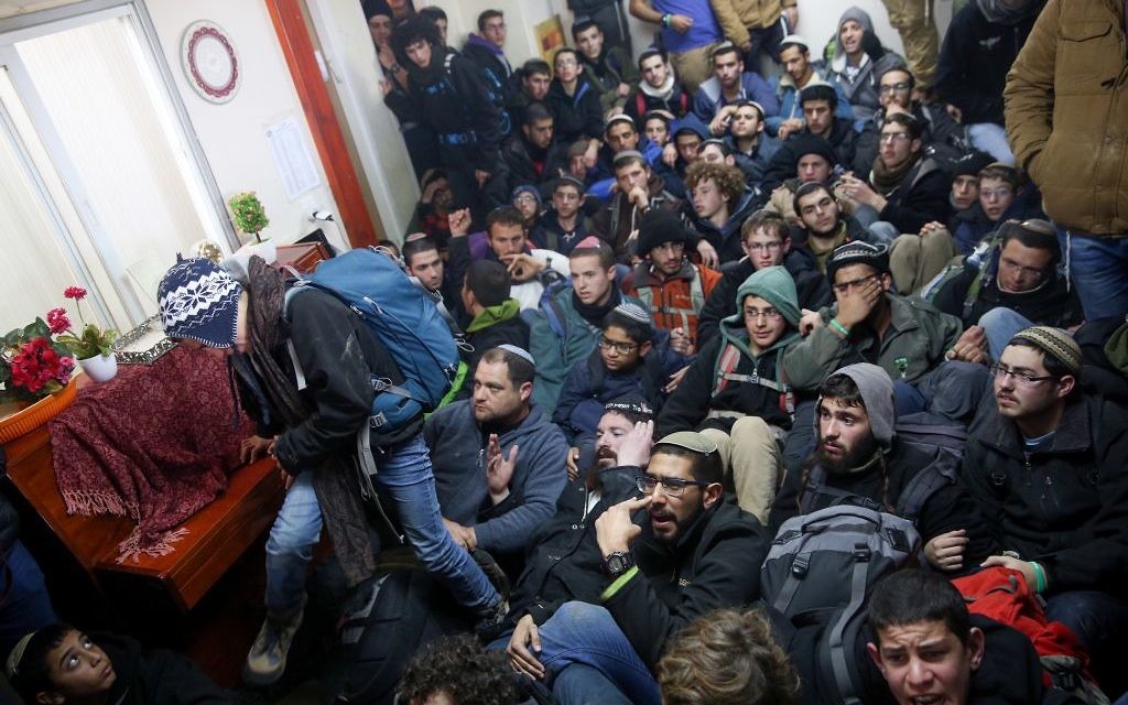 Israeli police evict settlers from the West Bank outpost of Amona, Wednesday. (Photo by: JINIPIX)