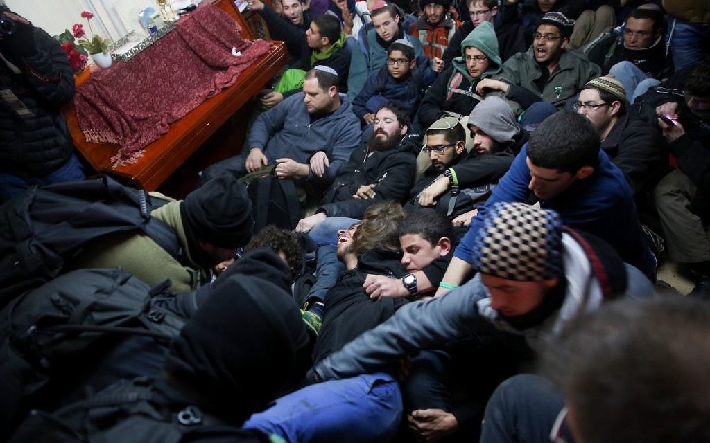 Israeli police evict settlers from the West Bank outpost of Amona, Wednesday. (Photo by: JINIPIX)