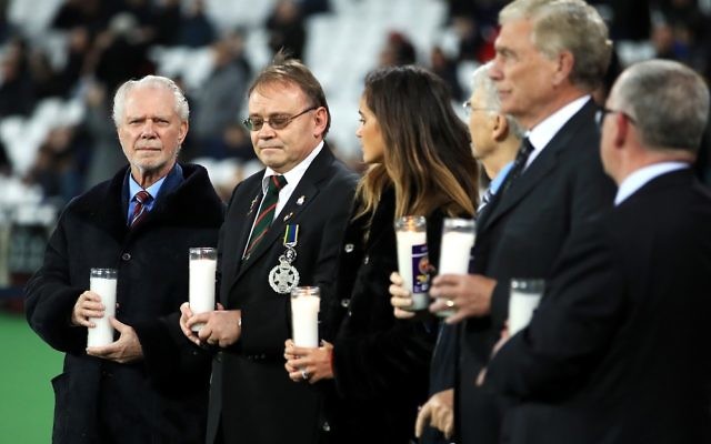 West Ham United co-chairman David Gold (left) holds a candle for Holocaust Memorial Day before the game