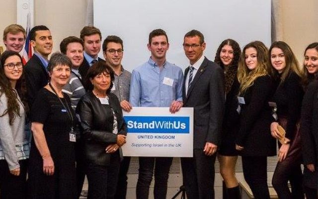 A group photo with a StandWithUs banner