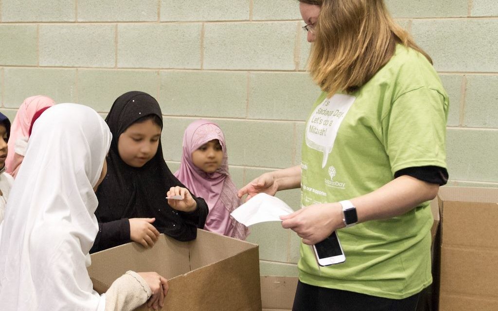 Jewish and Muslim volunteers collecting on Sadaqa Day Jewish and Muslim volunteers collecting on Sadaqa Day