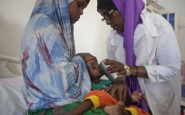 Photo by Save the Children of 15 month old Isse Mohamed, suffering from malnutrition, being cared for at the Stablisation unit at Garowe General Hoaspital, Puntland, Somalia. (Photo credit: Tom Pilston/Save the Children/PA)