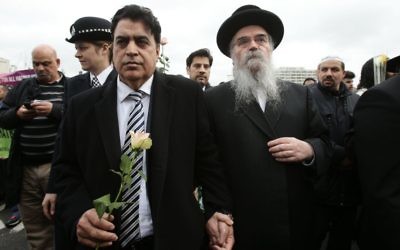 Rabbi Avraham Pinter (right) attends a vigil held on Westminster Bridge, exactly a week since the Westminster terror attack took place. (Photo credit: Yui Mok/PA Wire)