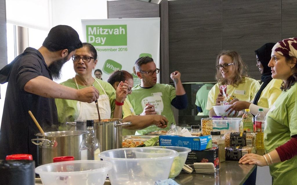 Jewish and Muslim volunteers cooking a three course meal for the homeless together, on Sadaqa Day Jewish and Muslim volunteers cooking a three course meal for the homeless together, on Sadaqa Day