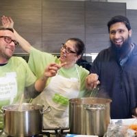 Jewish and Muslim volunteers cooking a three course meal for the homeless together, on Sadaqa Day