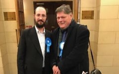 An Orthodox Conservative supporter celebrates the victory