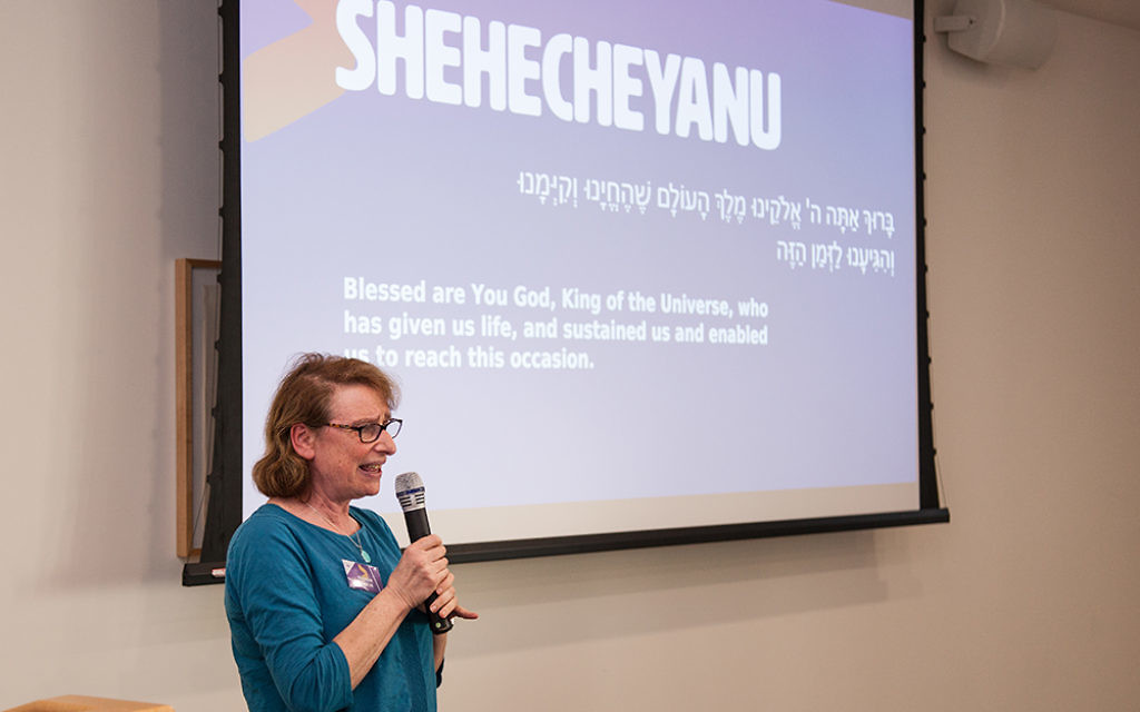 Maureen Kendler speaking at an interfaith seder in March 2017