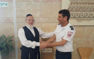 Magen David Adom and ZAKA officials shaking hands as they agree to save more lives together