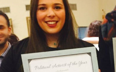 Izzy Lenga holding her 'Political Activist Of The Year' award