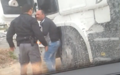 The officer assaulting the truck driver (Screenshot from Al Jazeera video)