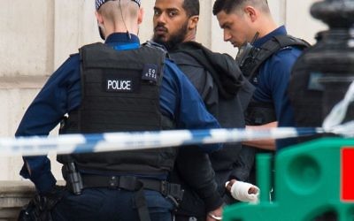 Armed police detaining a man following an incident in Whitehall, London. Terror police have been granted more time to question a suspected knifeman arrested in the heart of Westminster following a targeted swoop. (Photo credit: Dominic Lipinski/PA Wire)