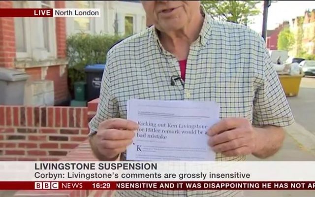 Ken Livingstone holding up a printed copy of a Jewish News article, on BBC news.