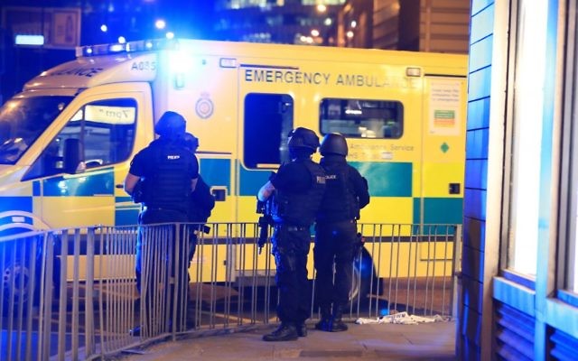 Armed police next to an ambulance after a suspected terrorist attack at the Manchester Arena at the end of a concert by US star Ariana Grande left 19 dead. 

Photo credit: Peter Byrne/PA Wire