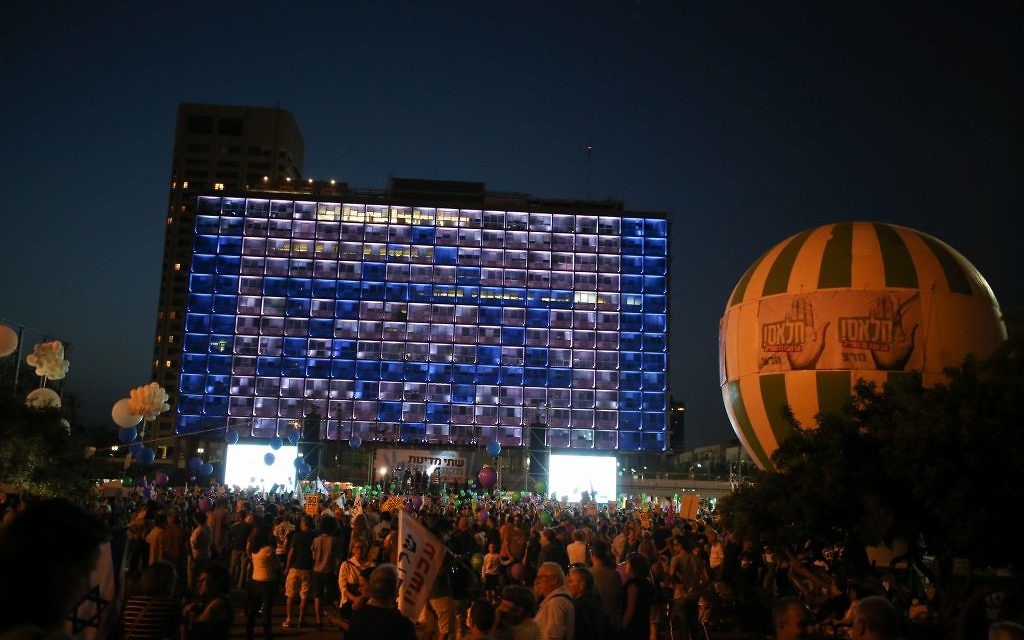 Israelis take part in a rally in support of establishing a Palestinian state alongside Israel to end the conflict, in Tel Aviv.
