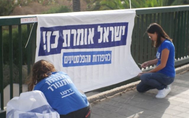 Young activists pinning up a banner for the campaign