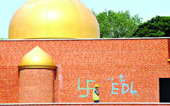 Hateful graffiti, including a swastika, daubed onto the wall o a mosque Hateful graffiti, including a swastika, daubed onto the wall o a mosque