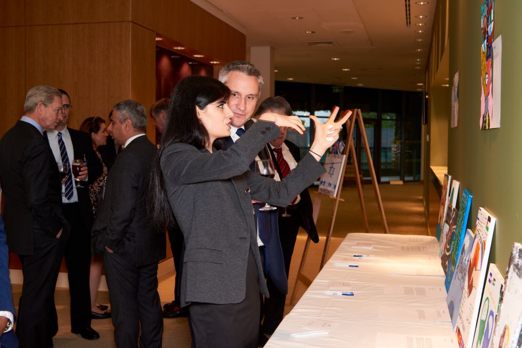 Aziza Rachidova and Richard Savage viewing the art exhibition and in the background Robin Searby and Pav Sanghera