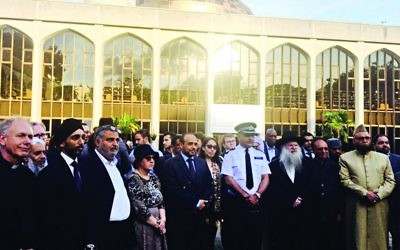 Members of different faiths together at a vigil following a terror attack