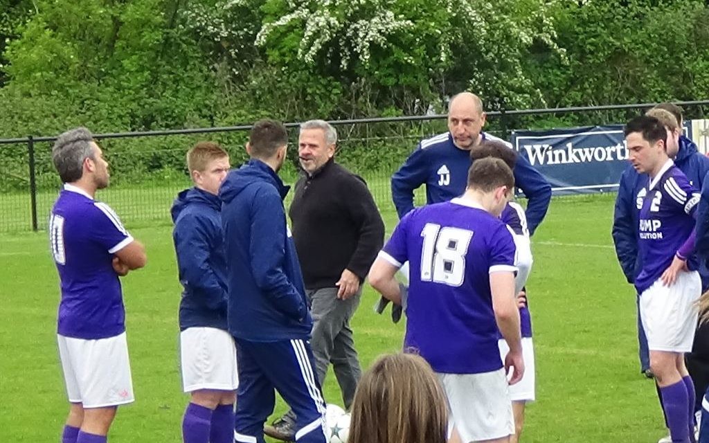 Dejected Redbridge players and management staff at the full-time whistle