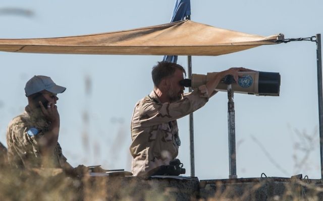 UN officials stationed in the Golan Heights look over into Syria to view the situation 
Photo by: Ayal Margolin- JINIPIX
